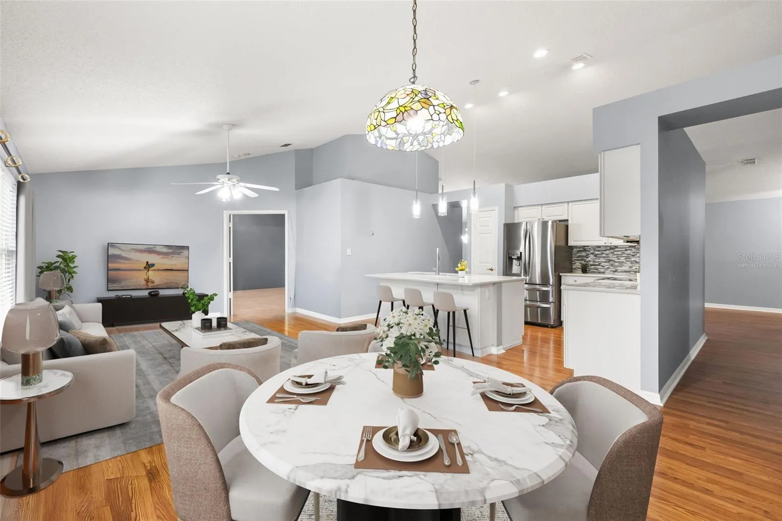 Virtually staged dinette and family room with views of recently updated kitchen and hallway to your secondary bedrooms and bath