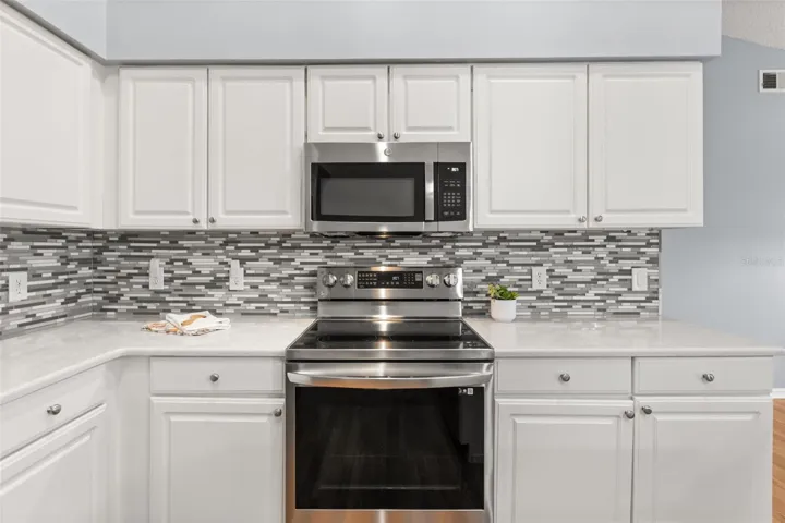 Quartz counters and tiled backsplash