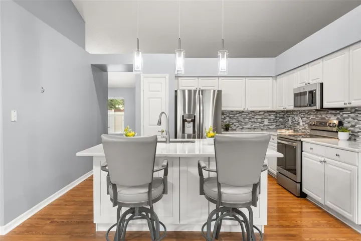 Large island with cabinets and updated pendant lighting