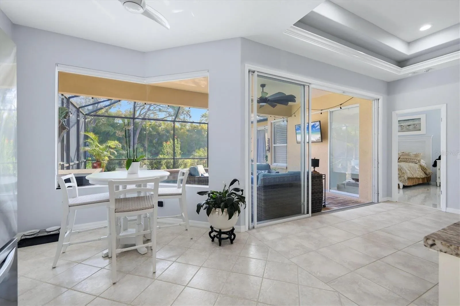 Breakfast Room w/aquarium window; slider to lanai and pool
