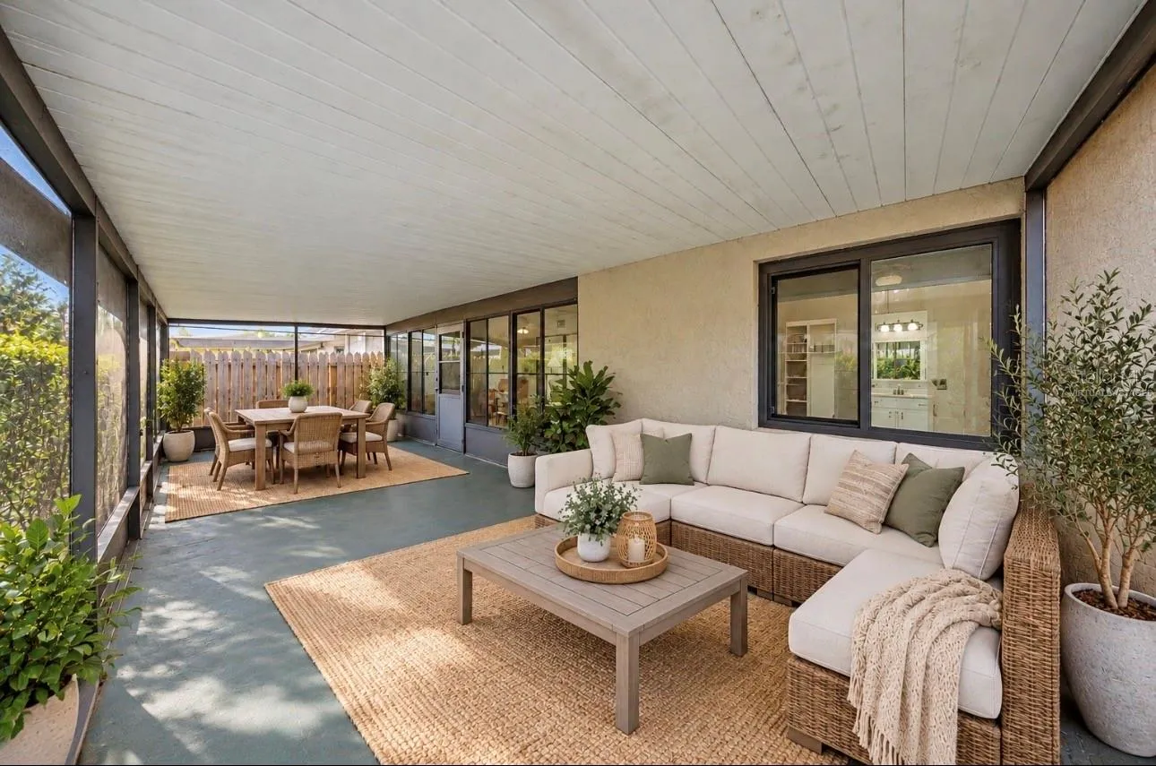 Expansive outdoor living with a screened room. Virtually staged for decorating ideas!