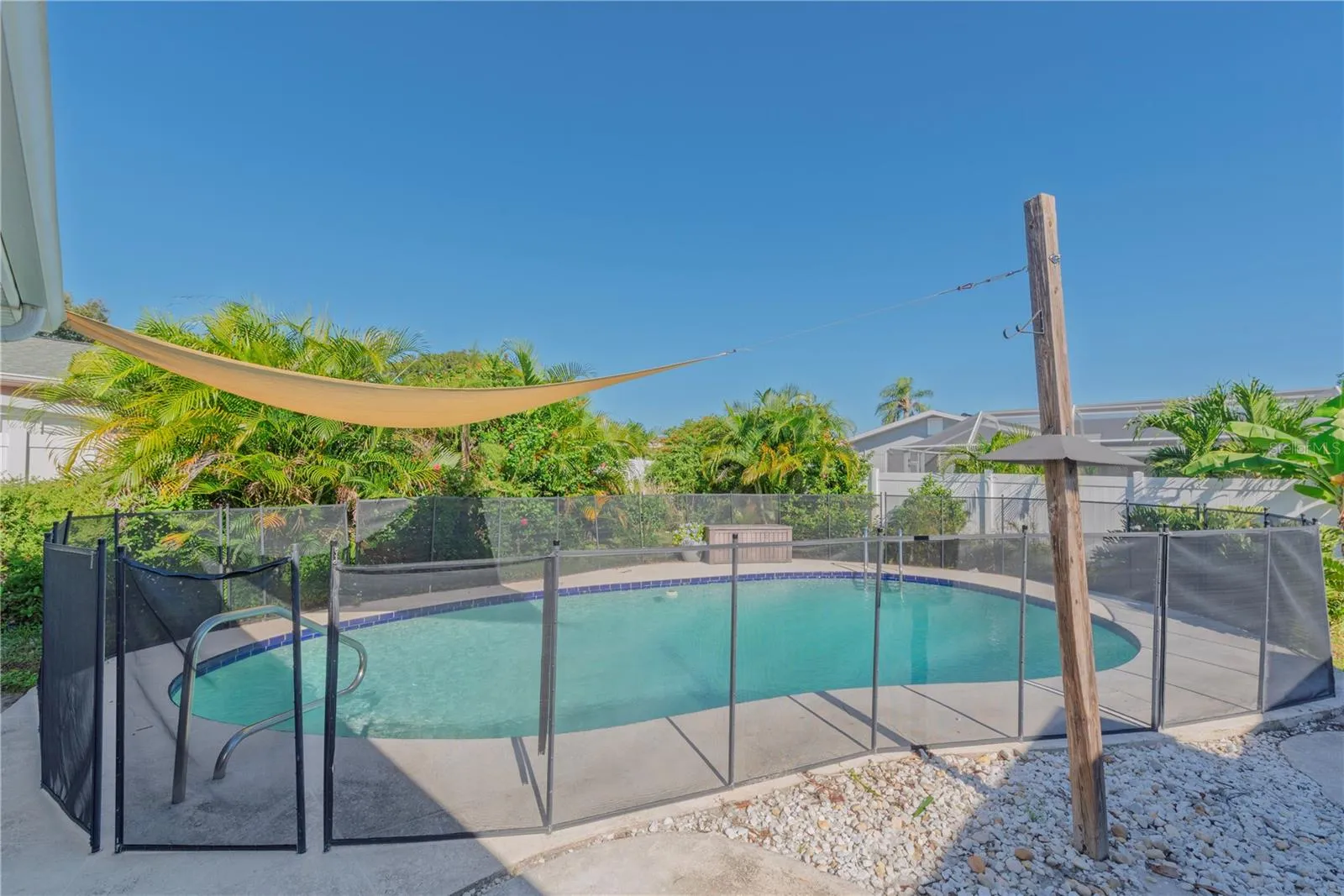 Private pool with safety fence.