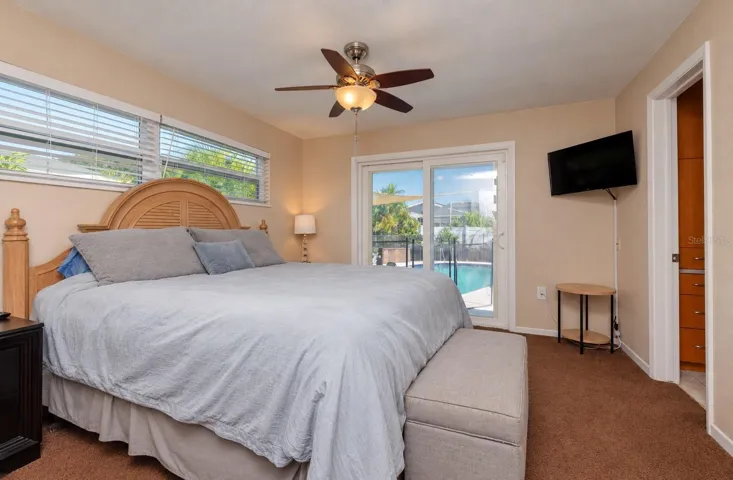 Primary bedroom with sliders to the pool lanai.