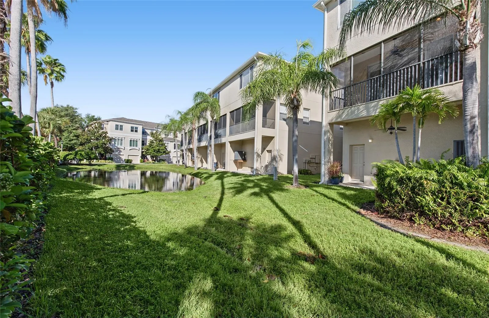 Back patio with ceiling fan and a nice retention pond where you will always see a family of ducks.