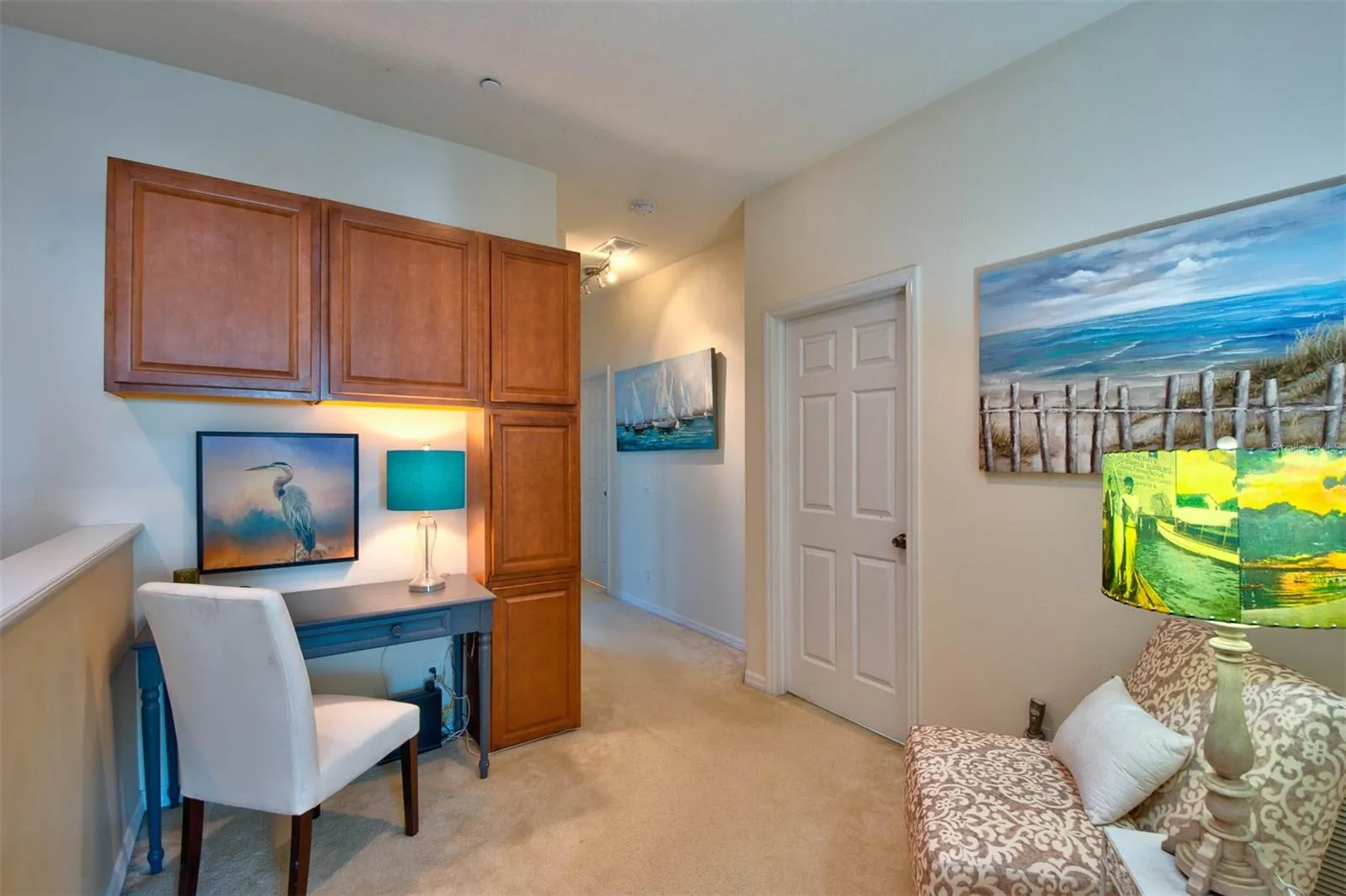 loft with desk area and laundry room