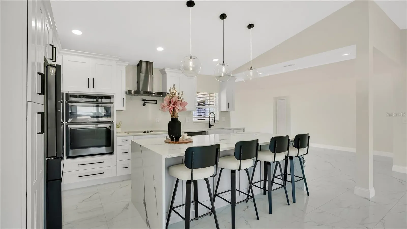 Kitchen with built-in oven and range hood