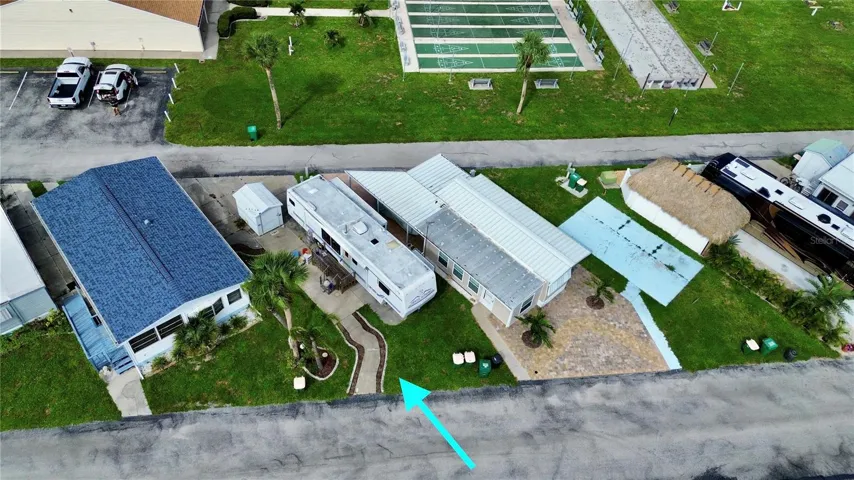 Aerial of lot and RV that is being left at the property for convenience of the seller/buyer.