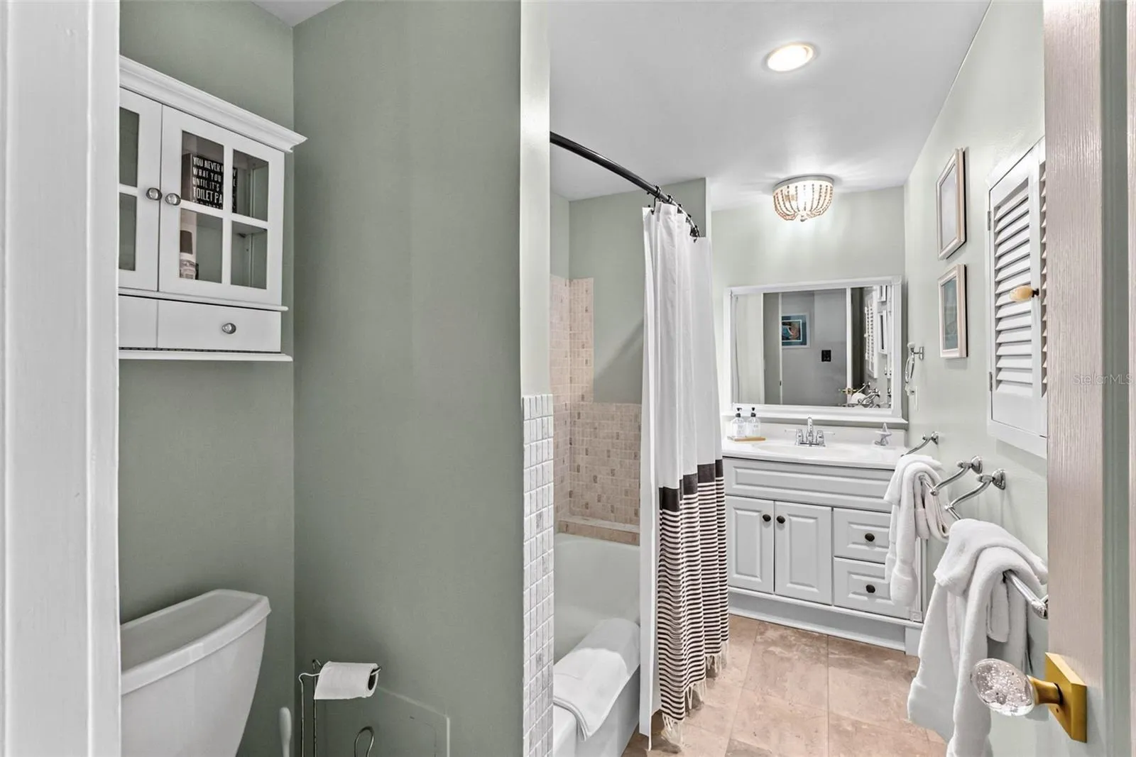 Guest bathroom with vanity and tub/shower combination.