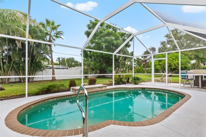 Screened swimming pool with patio space.