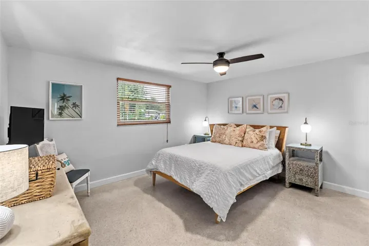 Primary bedroom with coordinating coastal furnishings.