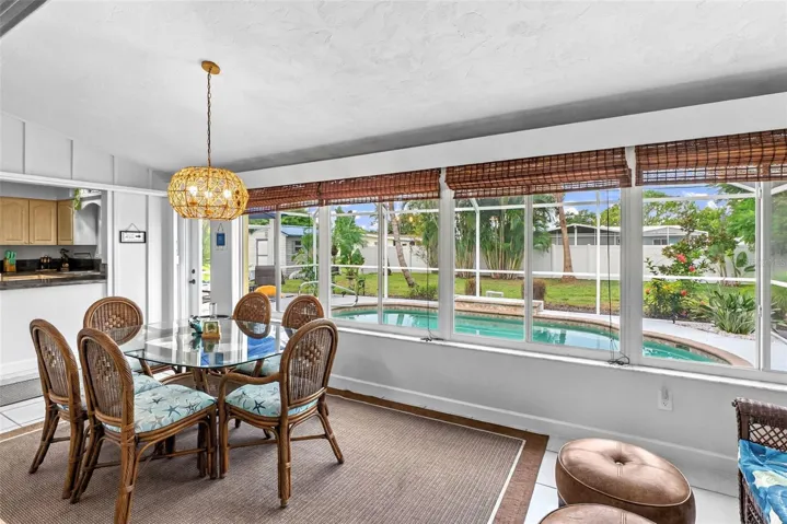 Florida room dining area with pool views.