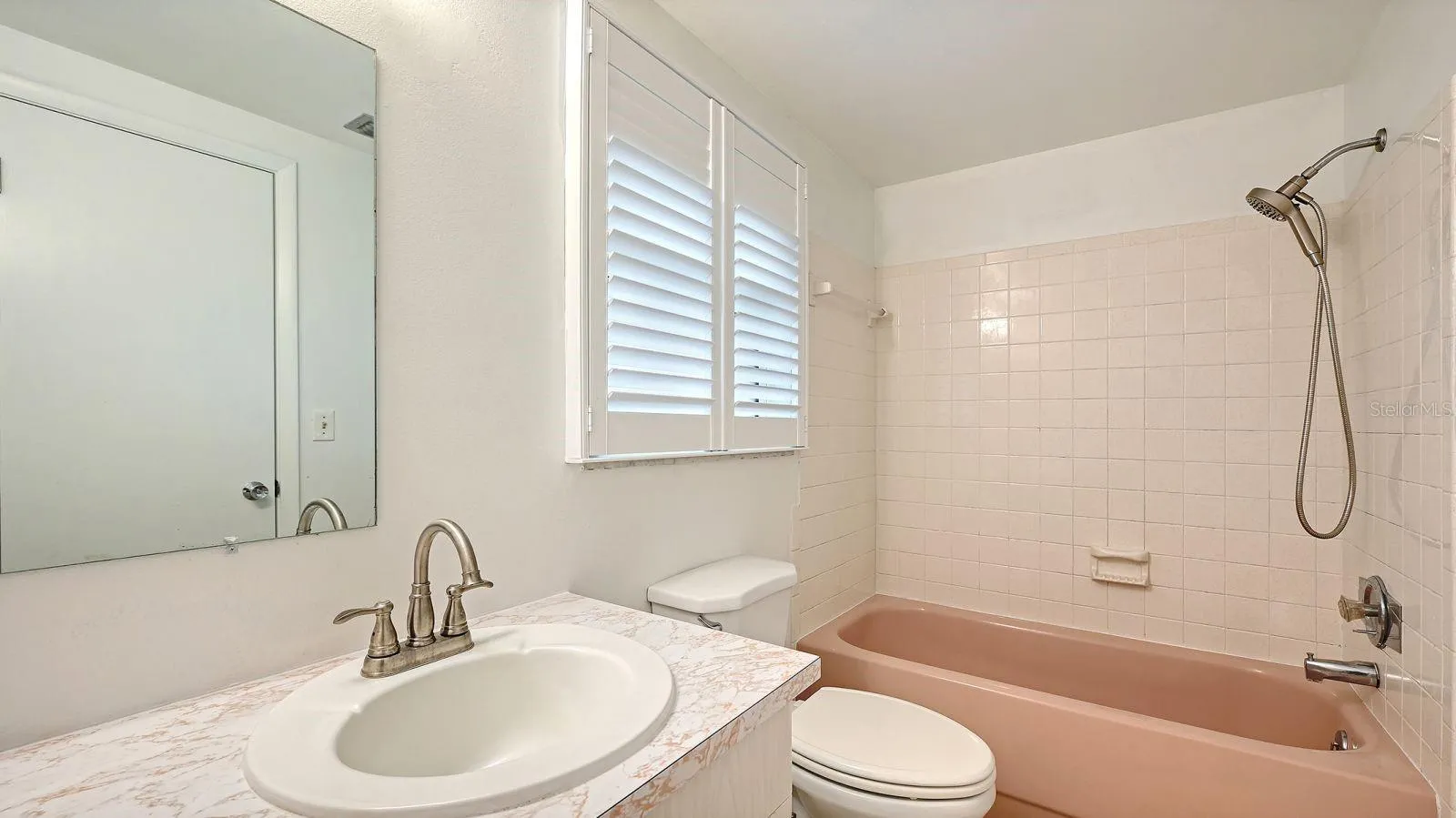 Primary Bathroom with a Tub/Shower Combo.