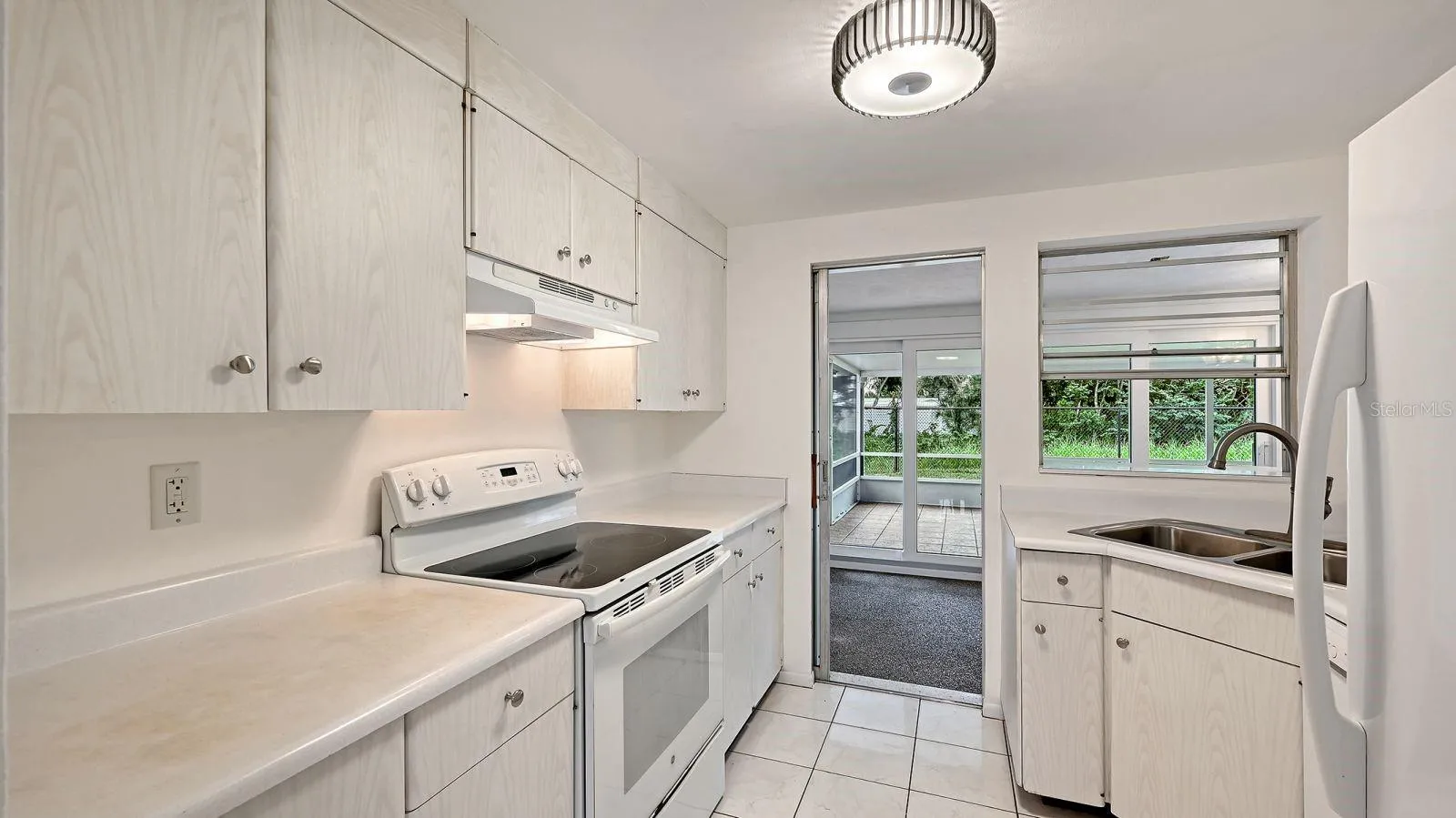 Kitchen with pass thru window and door to the Florida Room