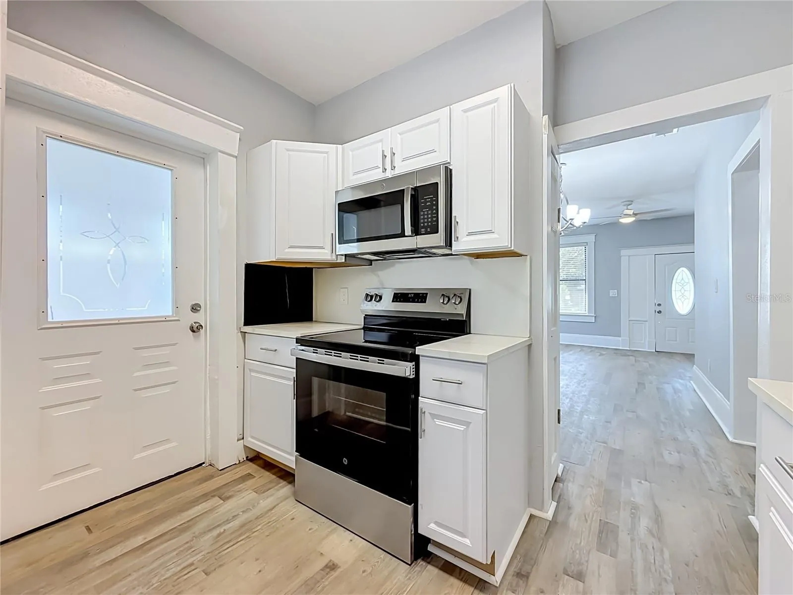 Updated Kitchen with New Stainless Steel Appliances with access to covered patio outside