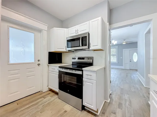 Updated Kitchen with New Stainless Steel Appliances with access to covered patio outside