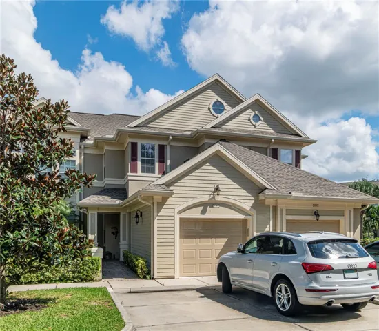 Front Elevation.  One car garage and two parking spaces out front.  Entrance on the left side, OR by elevator in the garage.  Unit is the entire second story and an end unit for additional windows and light