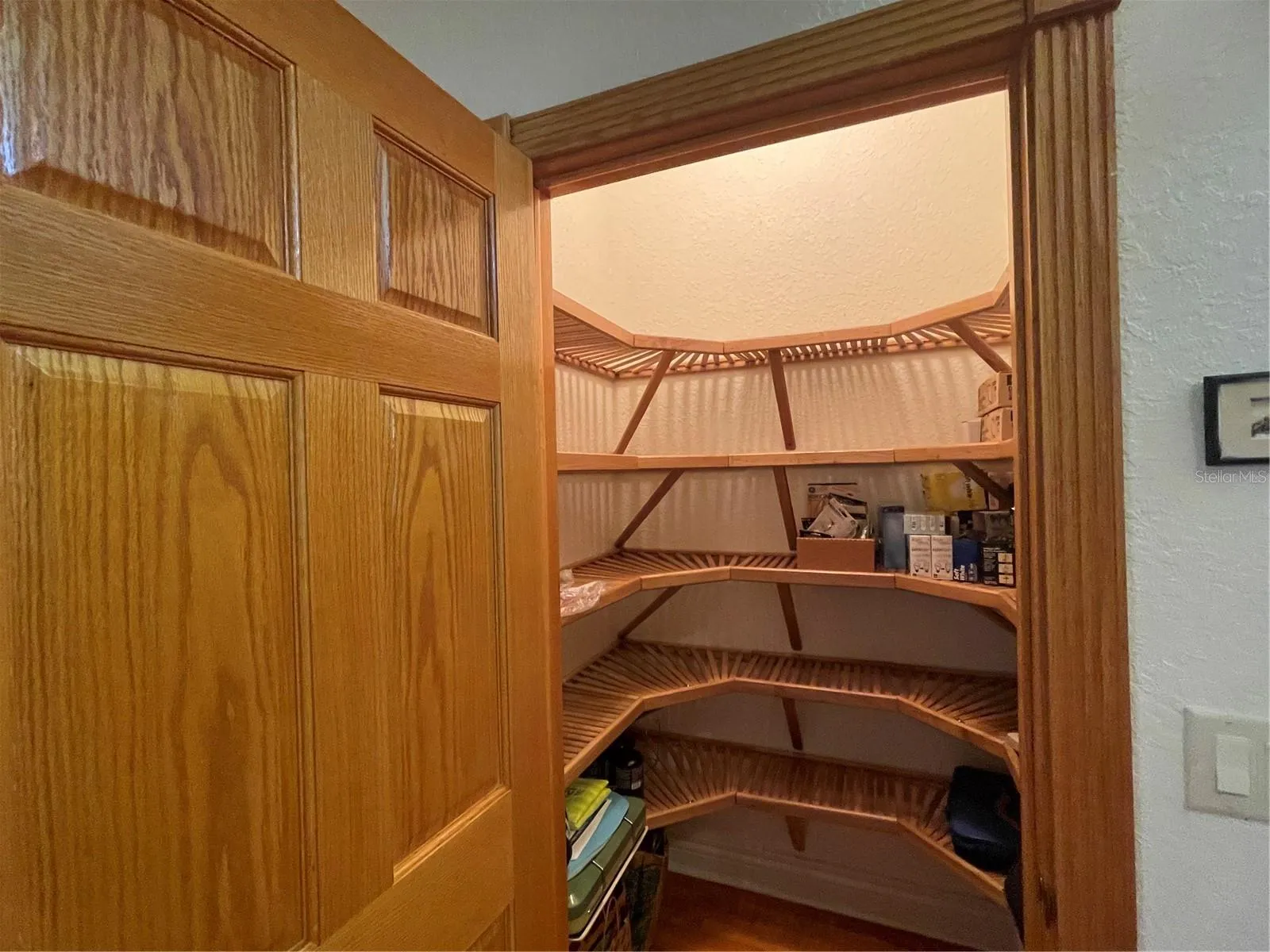 Walk in closet in 2nd bedroom has wood shelving.