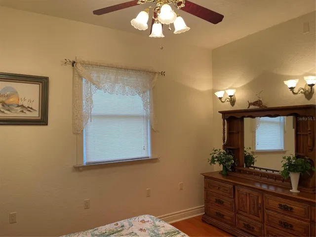 2nd bedroom has brass ceiling fan and recessed ligthing.