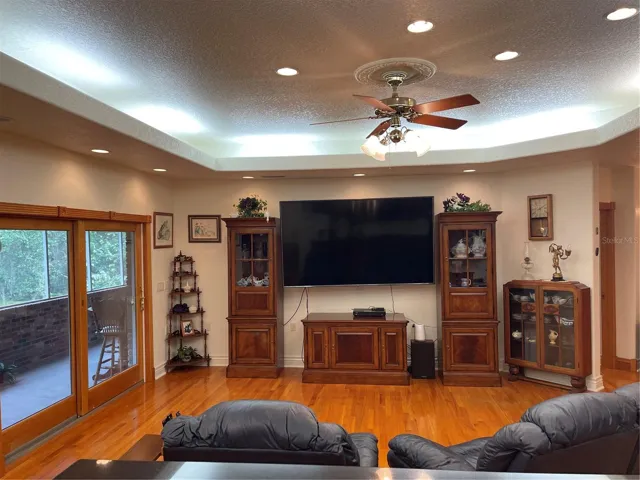 Living room exits through Anderson sliding glass doors to the screened balcony