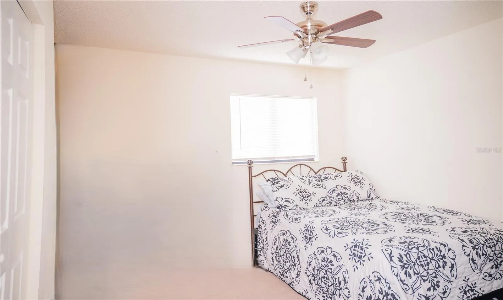 Third bedroom, currently staged as a guest suite.