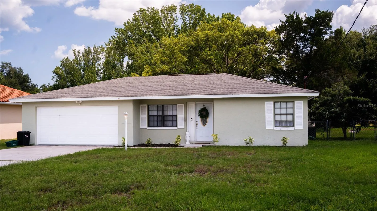 Front view of the house, showing off the exterior, yard, and driveway.