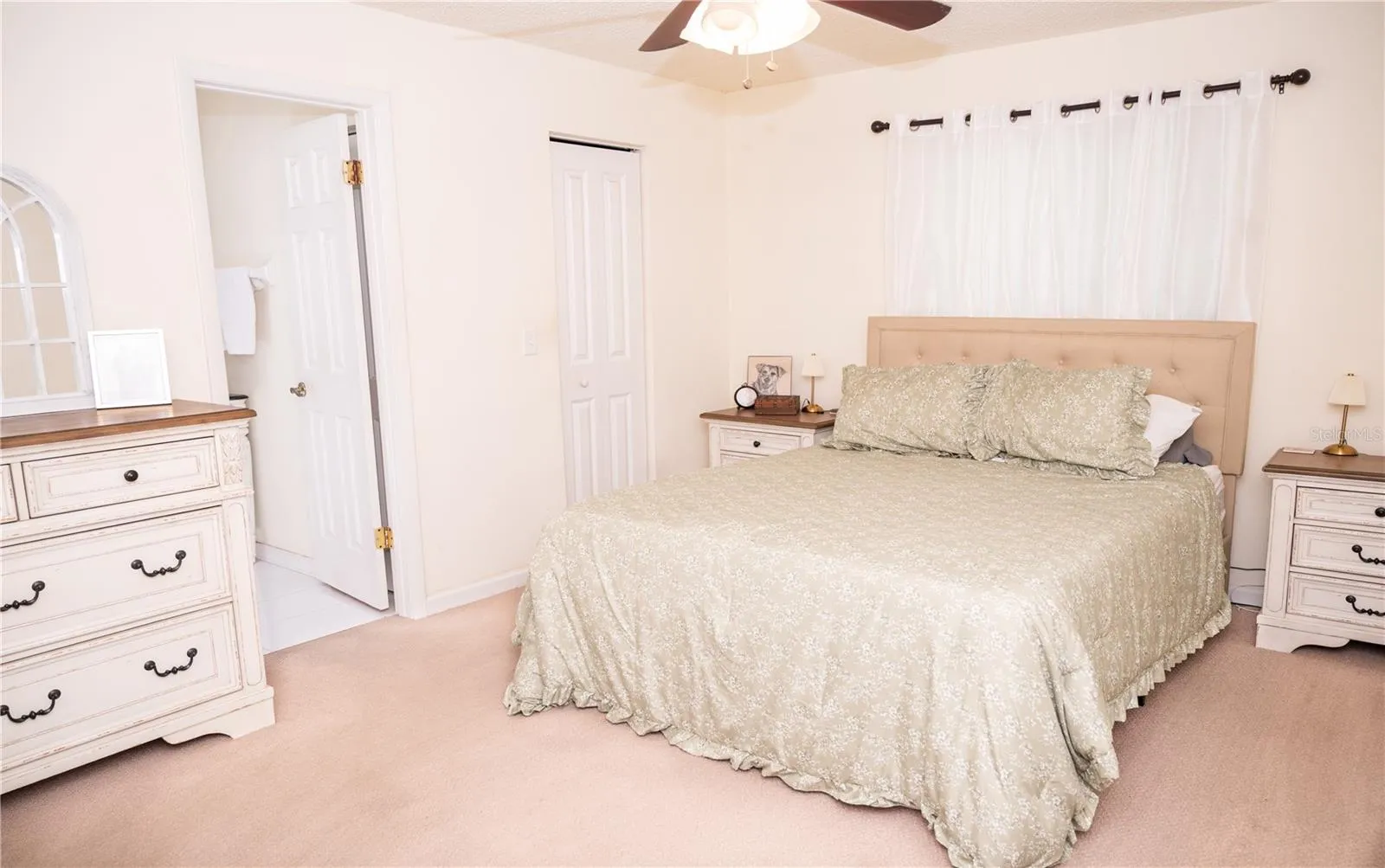 Primary bedroom view featuring the walk-in closet and primary ensuite bathroom.