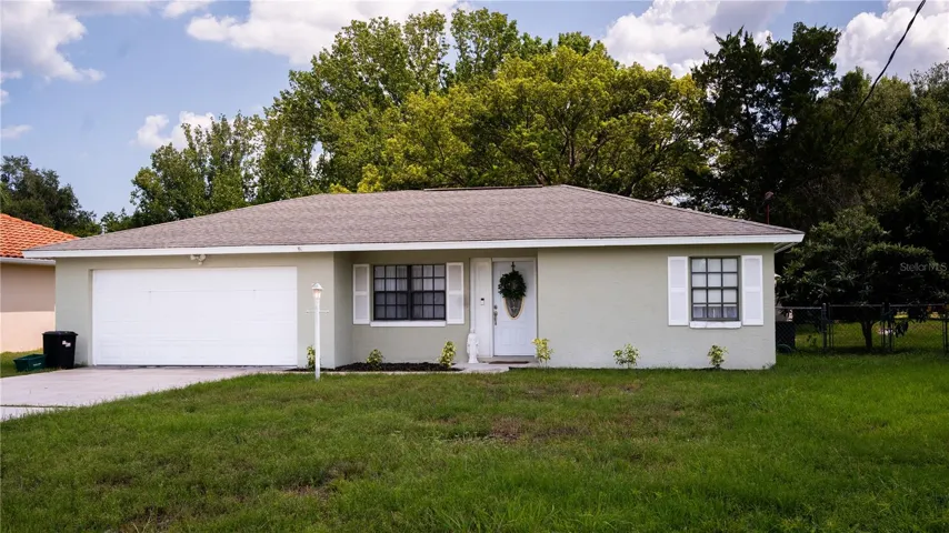 Front view of the house, showing off the exterior, yard, and driveway.
