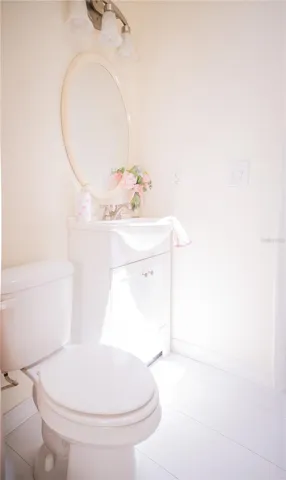 Modern vanity featuring sleek, elegant granite countertop with chrome hardware, and spacious cabinetry for optimal storage in the second bathroom.