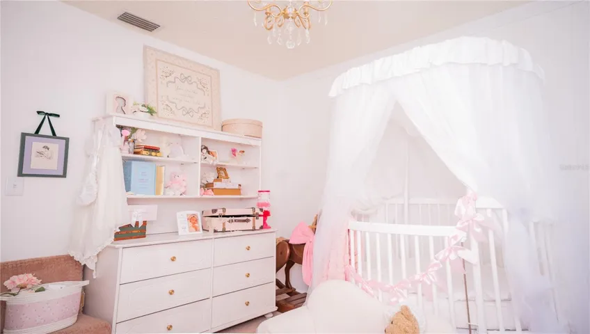 Another view of the nursery, complete with the chandelier ceiling fixture.