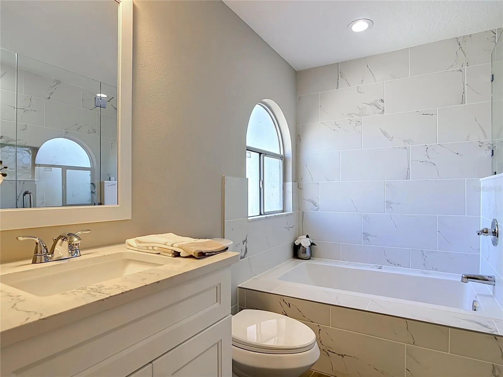Primary bathroom with soaking tub and separate shower.