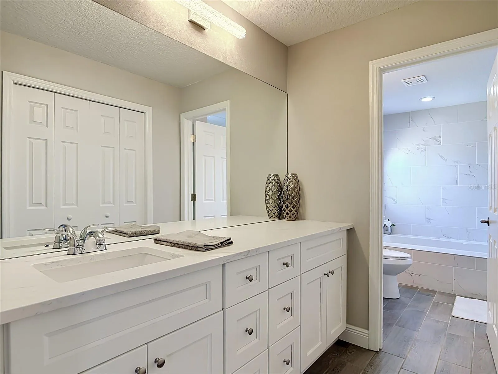 Primary bathroom with separate vanities.