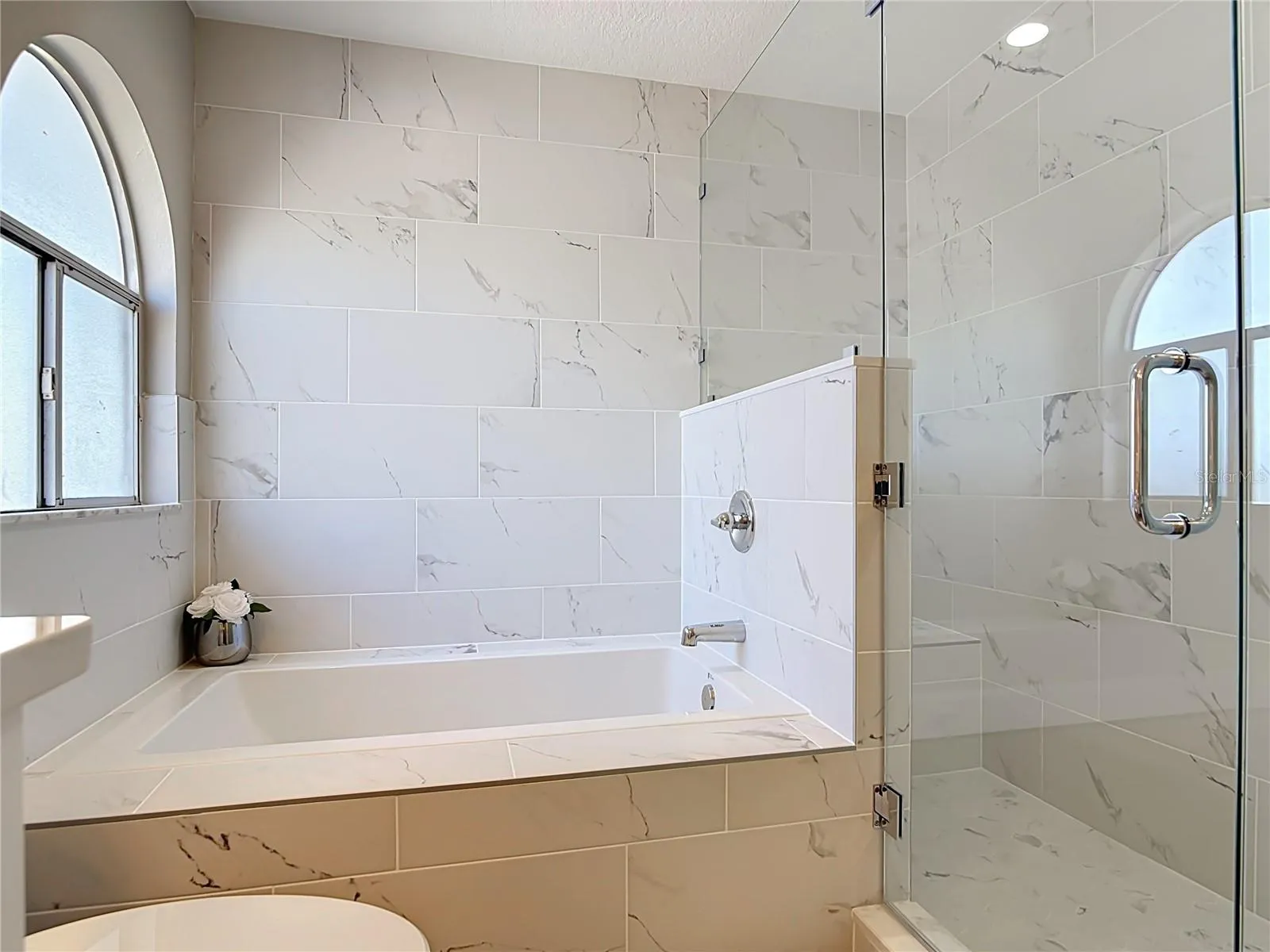 Primary bathroom with soaking tub and separate shower.