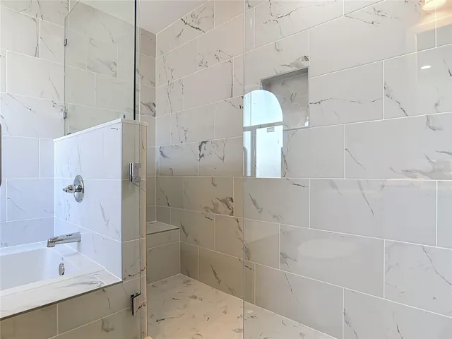 Primary bathroom with tub and shower.