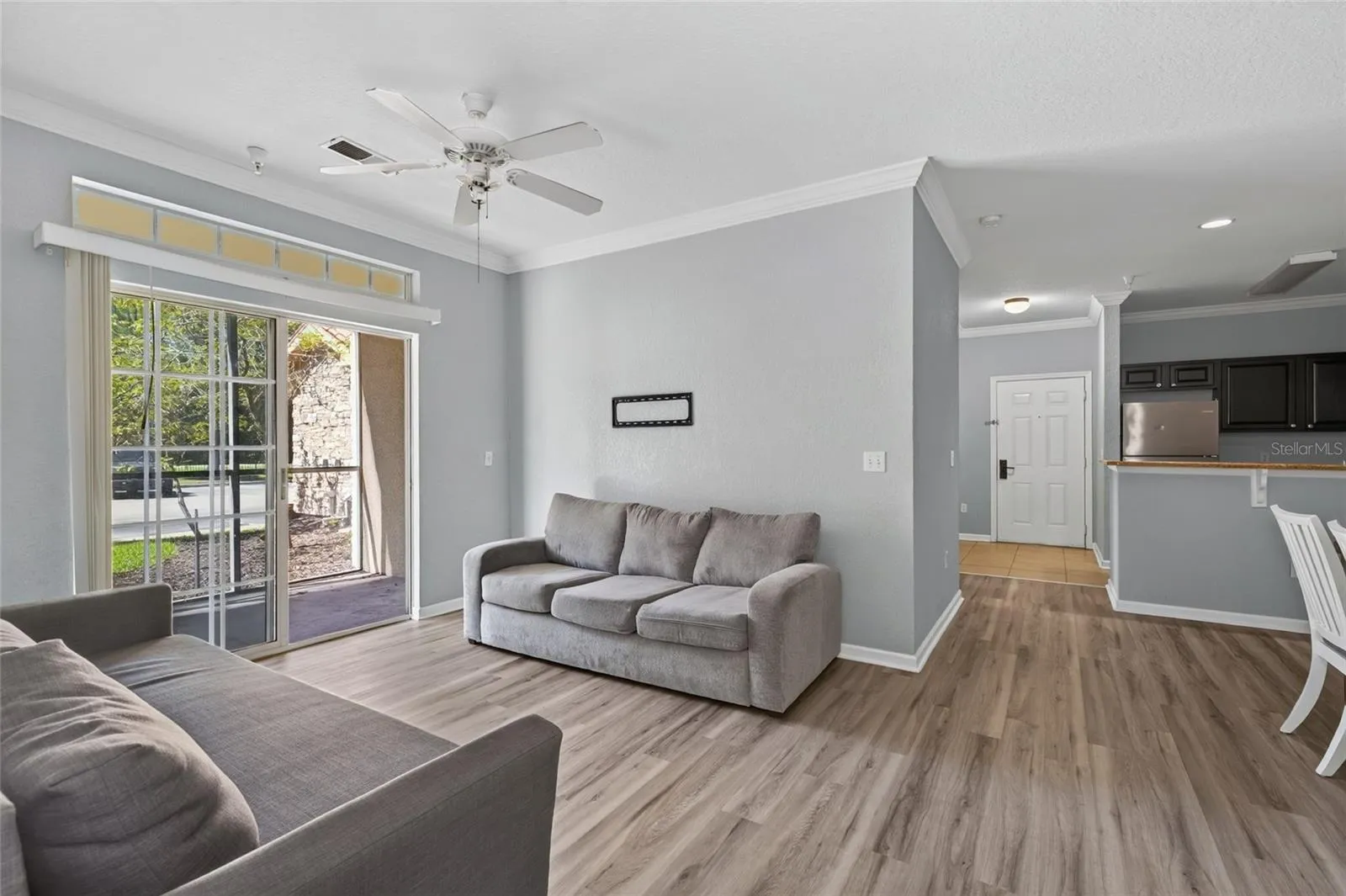 LIVING ROOM & SCREENED PATIO, Southwest facing. Front entry and kitchen directly ahead.