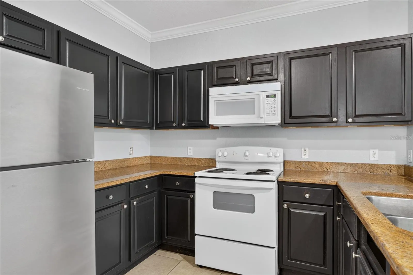 KITCHEN. Appliances include: Refrigerator, stove/oven, microwave. No dishwasher.