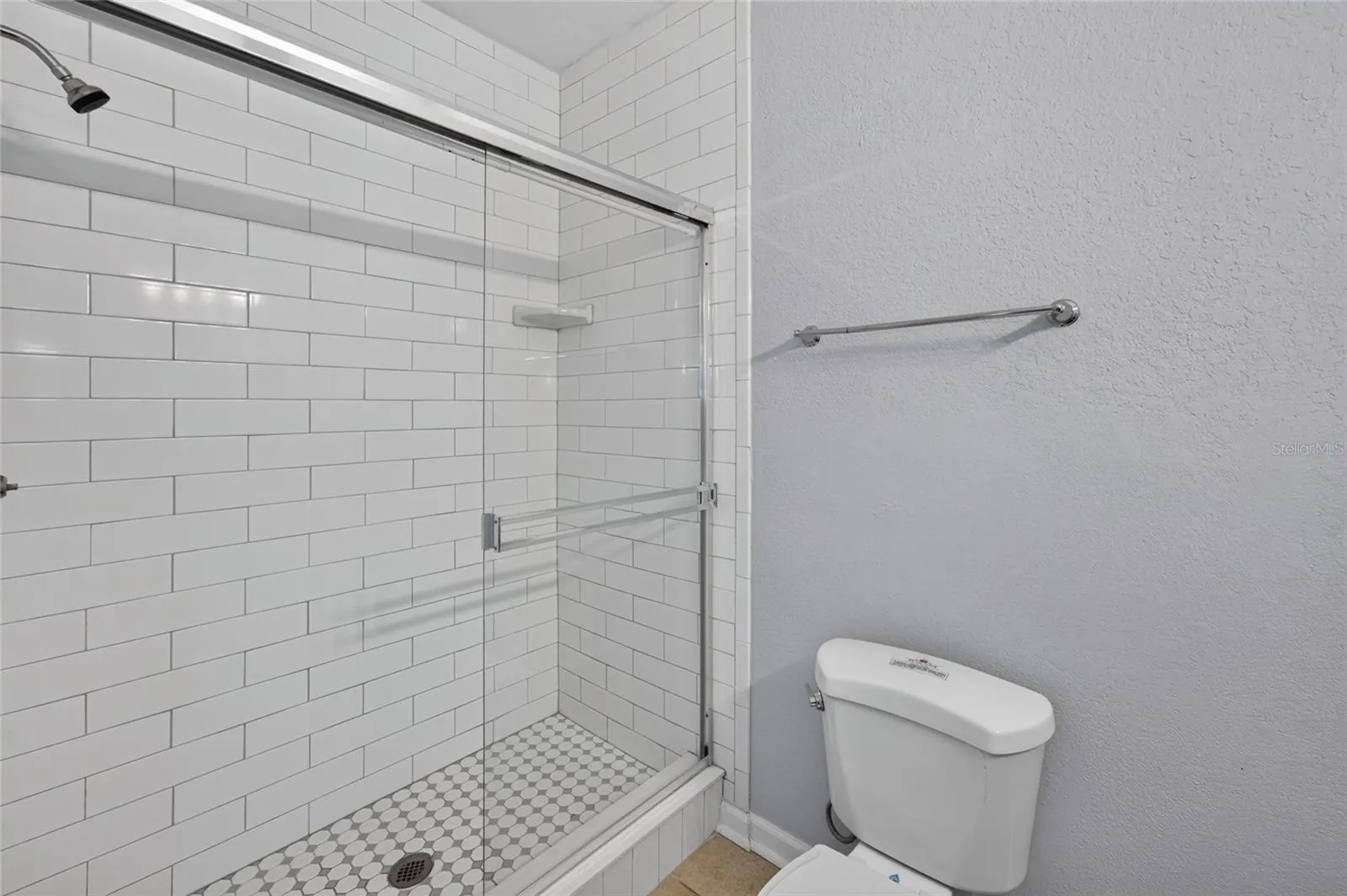 PRIMARY BATHROOM, subway tile walls.
