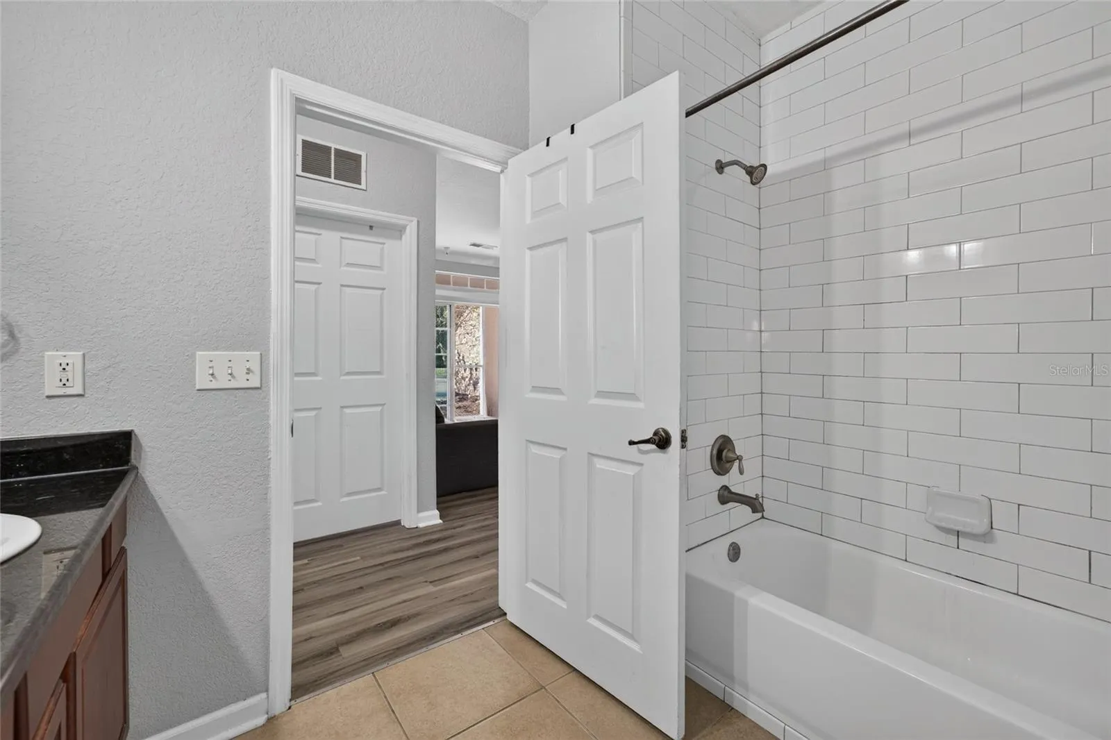 FULL BATH, HALLWAY. Shared bathroom for 2nd and 3rd bedrooms. 2nd bedroom directly across bath. 3rd bedroom (to the left).