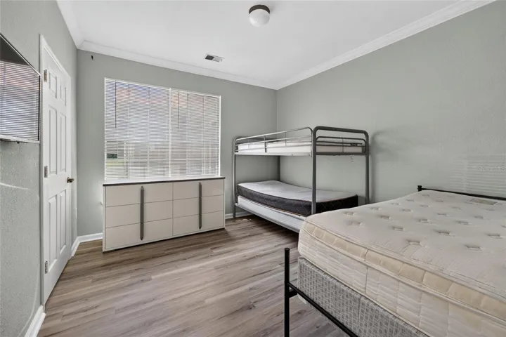 PRIMARY ENSUITE BEDROOM. BUILT-IN CLOSET (left door next to windows). SW facing light.