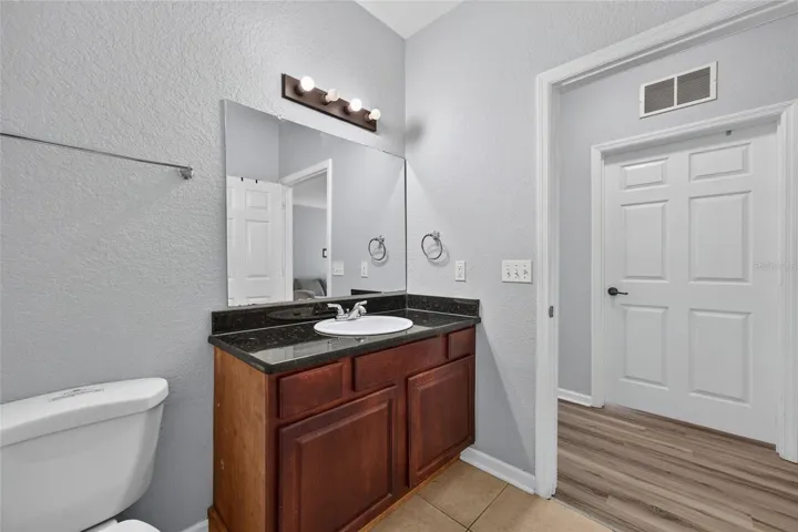 FULL BATH, BACK HALLWAY.  2nd bedroom directly across, and 3rd bedroom (to the left).