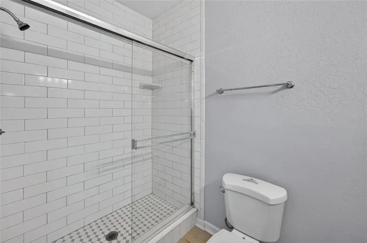 PRIMARY BATHROOM, subway tile walls.