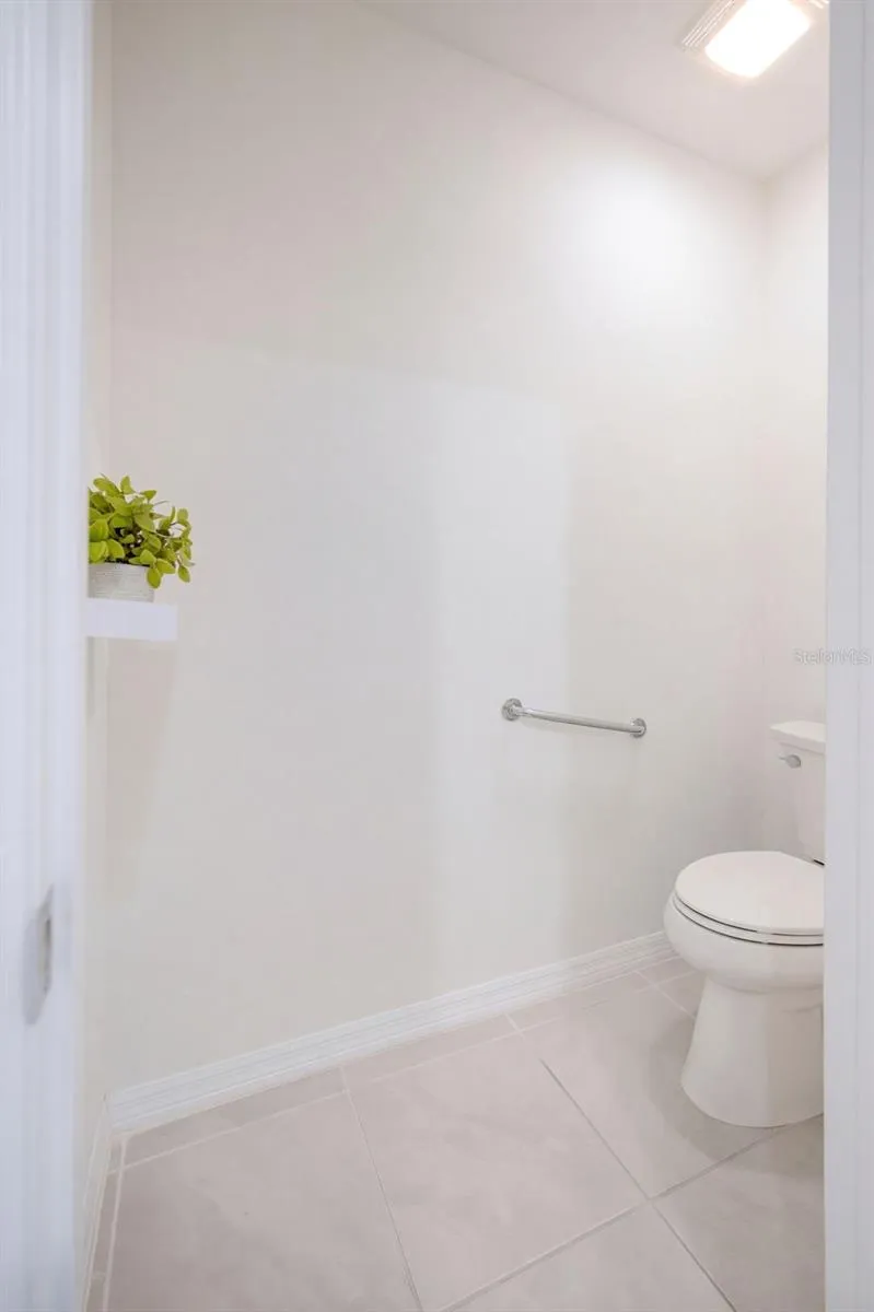 A private water closet includes a comfort-height toilet with a safety grab bar
