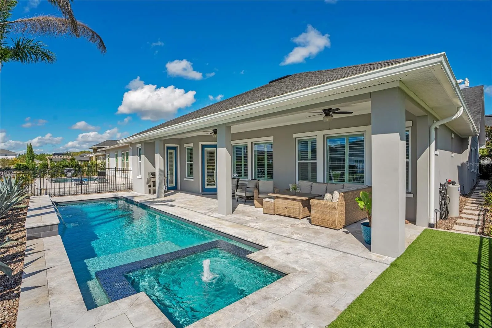 Rear exterior with private heated salt water pool and covered extended lanai. Florida outdoor living in Lake Nona, Orlando.