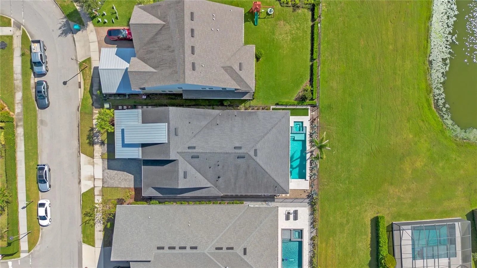 Overhead aerial showing the home, private pool, and fenced backyard.