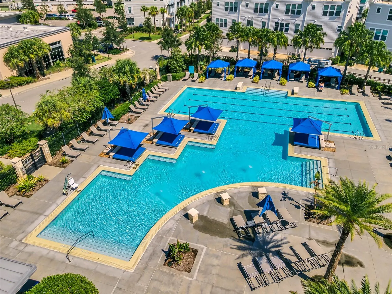 Community pool with shaded cabanas and sun deck in Laureate Park, Orlando FL 32827.