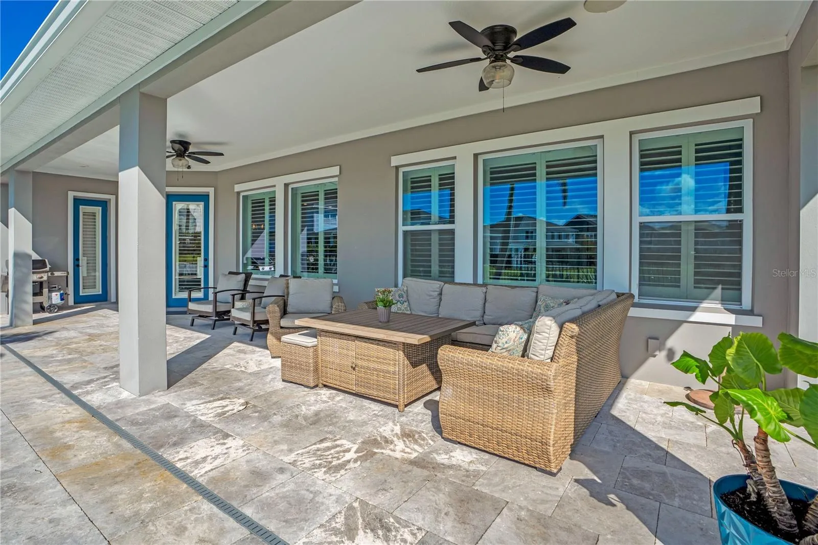 Covered lanai lounge with ceiling fan, perfect for relaxing year round in Central Florida.