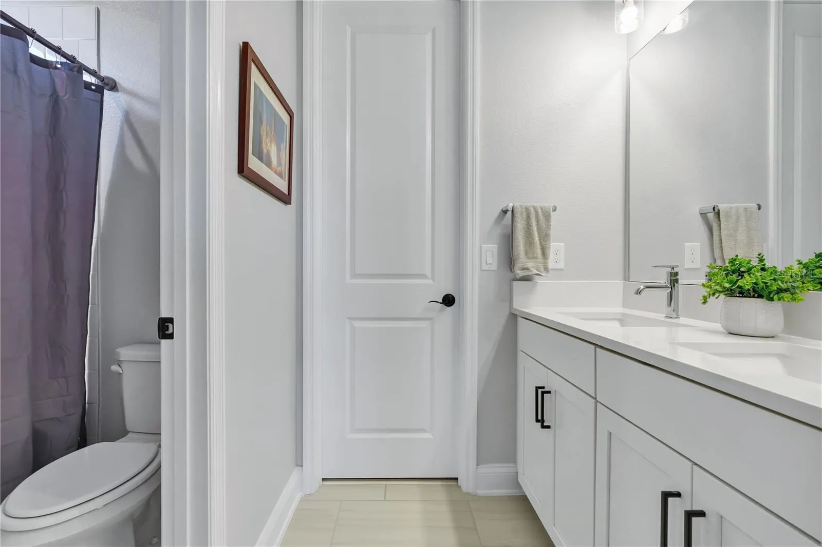 Full bath with shower and tub combination and quartz vanity.