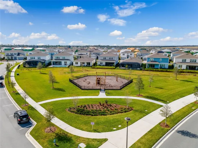Landscaped neighborhood park with winding walking paths in Laureate Park.