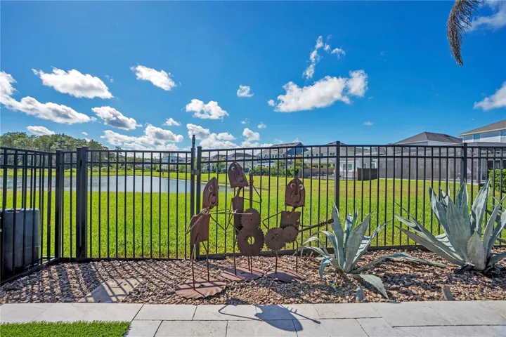 Fenced backyard opening to a water and conservation view behind the home.