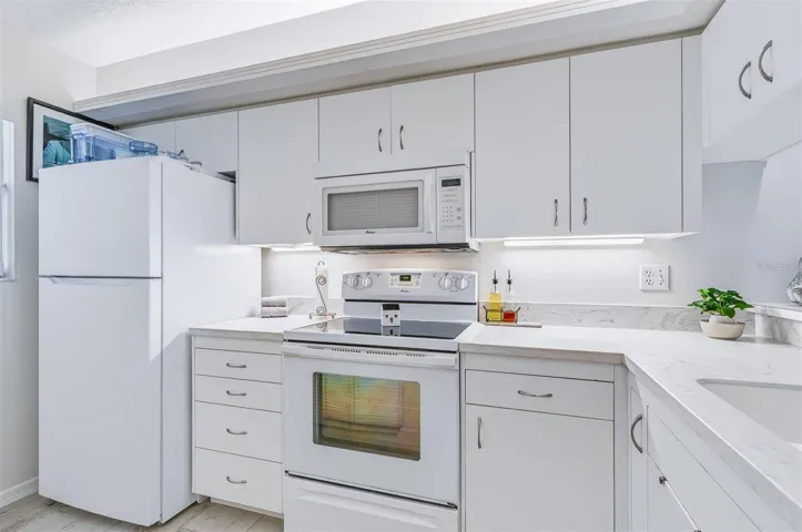 kitchen with white bright appliances