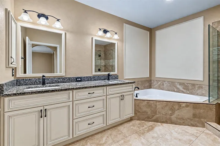 Second floor bathroom with double vanity, granite tops, dual sinks and garden tub